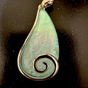 Charm with beautiful blue green stone.